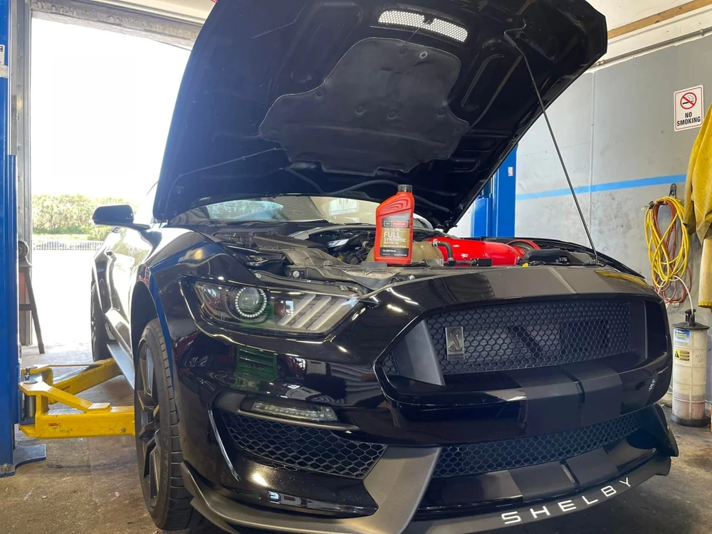 Vehicle with its hood open for service at Jupiter Car-Care in Jupiter
