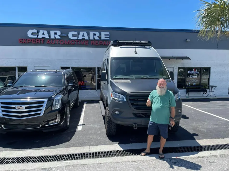 Customer standing outside the Jupiter Car-Care storefront in Jupiter
