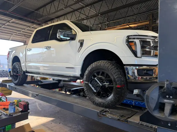 White pickup truck on the alignment rack at Jupiter Car-Care in Jupiter